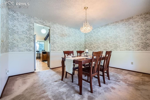 dining area with carpet floors and an inviting chandelier