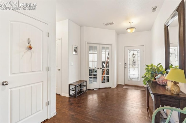 foyer entrance with french doors and dark hardwood / wood-style flooring