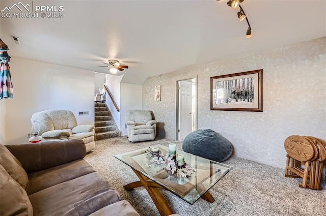 living room featuring ceiling fan, rail lighting, and carpet