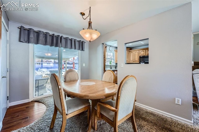 dining area featuring dark wood-type flooring