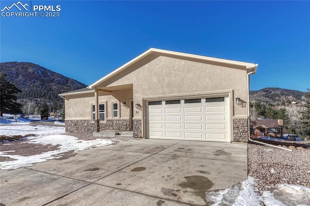 view of front of home with a mountain view and a garage