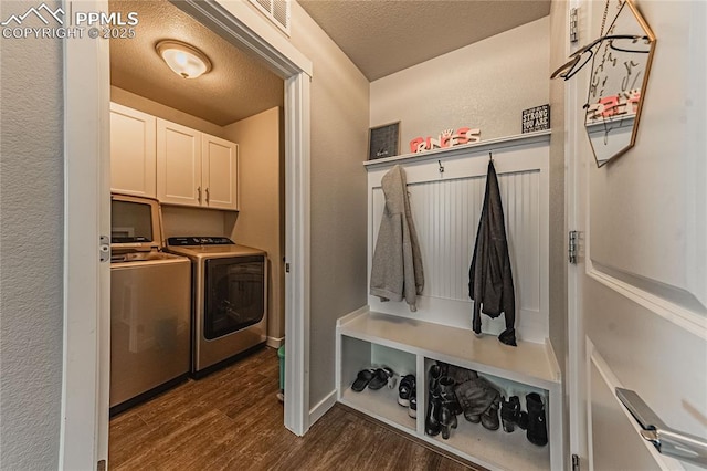 mudroom with a textured ceiling, dark hardwood / wood-style flooring, and separate washer and dryer