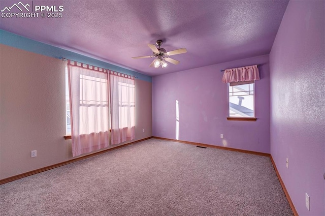 unfurnished room with carpet flooring, a textured ceiling, and ceiling fan