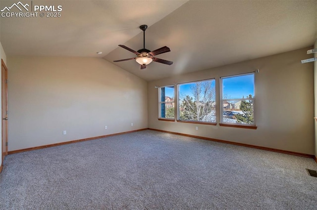 carpeted spare room with ceiling fan and lofted ceiling