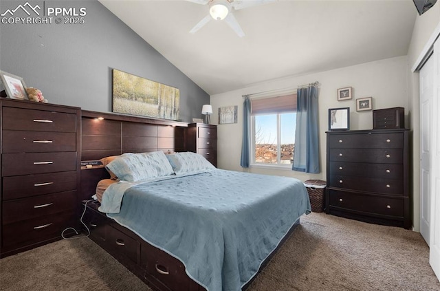 carpeted bedroom with a closet, vaulted ceiling, and ceiling fan