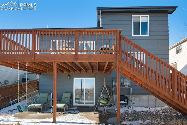 snow covered property featuring a wooden deck