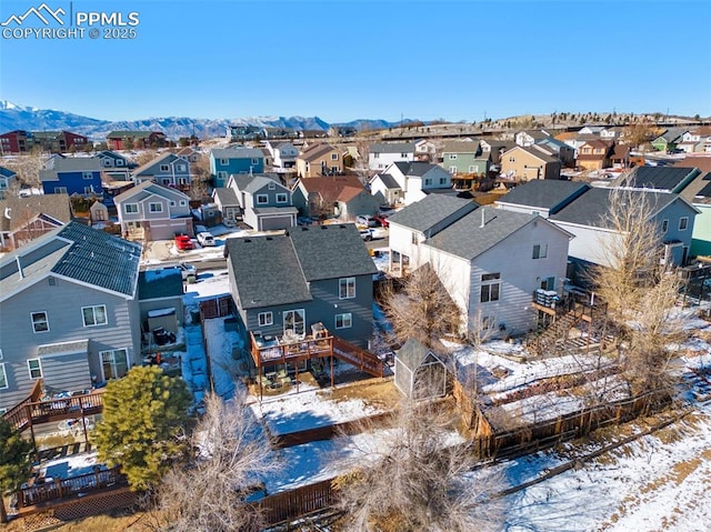 snowy aerial view with a mountain view