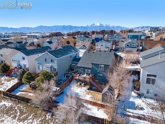 snowy aerial view with a mountain view