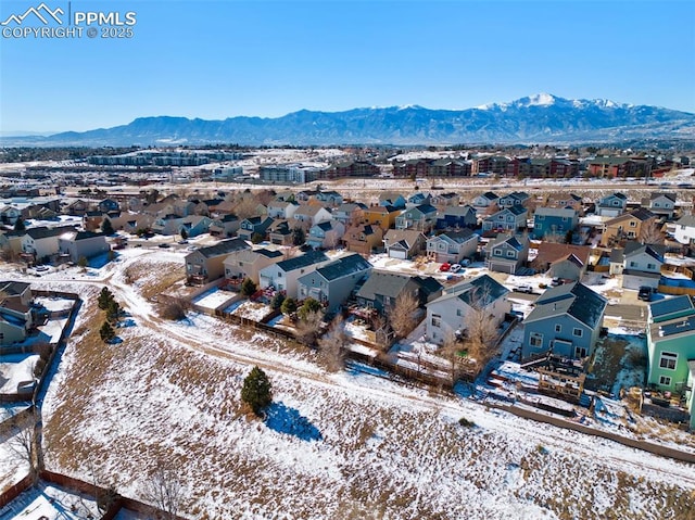 snowy aerial view with a mountain view