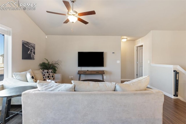 living room with ceiling fan and dark wood-type flooring