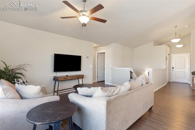 living room featuring lofted ceiling, ceiling fan, and dark wood-type flooring