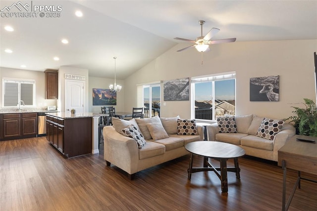 living room featuring dark hardwood / wood-style floors, sink, ceiling fan with notable chandelier, and vaulted ceiling