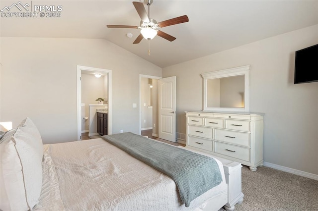 carpeted bedroom with vaulted ceiling, ensuite bath, and ceiling fan