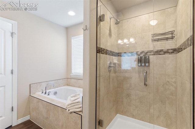 bathroom featuring hardwood / wood-style flooring and shower with separate bathtub