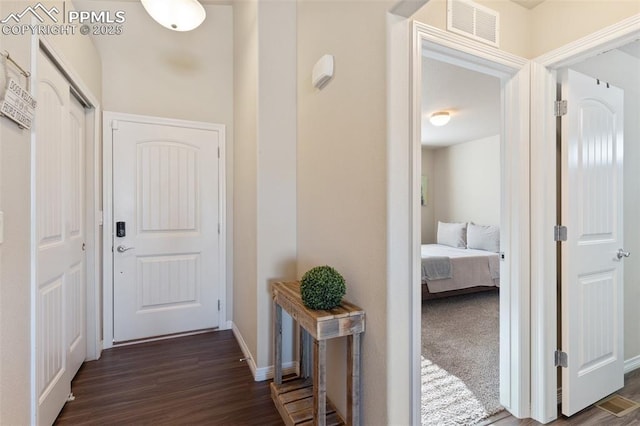 hall with dark hardwood / wood-style flooring