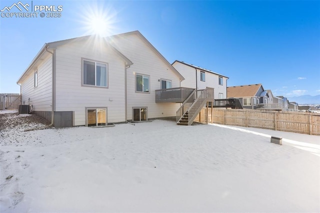 view of snow covered back of property