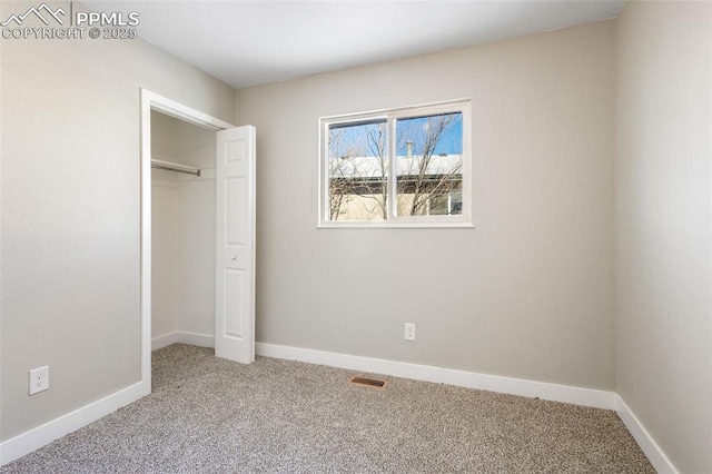 unfurnished bedroom with carpet floors and a closet