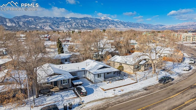 snowy aerial view with a mountain view