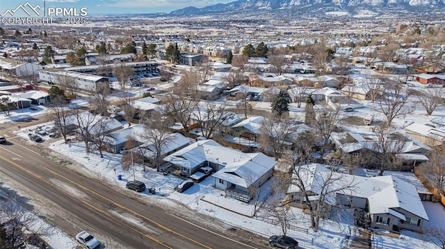 snowy aerial view featuring a mountain view