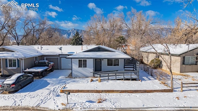 view of front facade featuring a garage and a mountain view