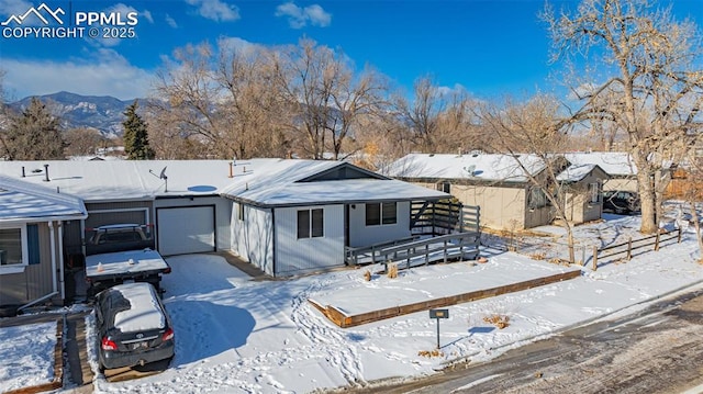 single story home with a mountain view and a garage