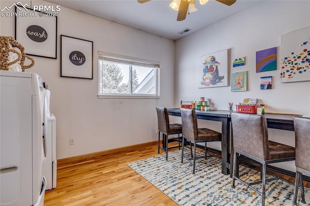 dining room with ceiling fan, washer and dryer, and light hardwood / wood-style flooring