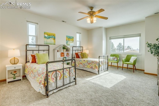 carpeted bedroom featuring ceiling fan and multiple windows