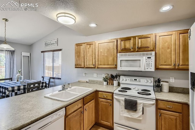 kitchen featuring white appliances, hanging light fixtures, sink, plenty of natural light, and lofted ceiling