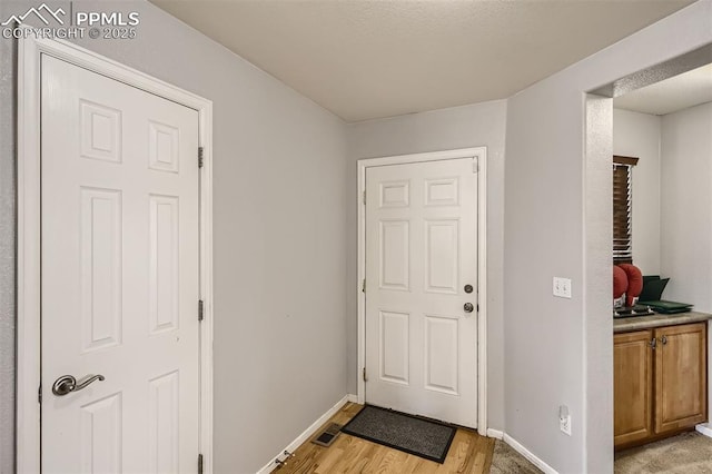 doorway to outside featuring light wood-type flooring