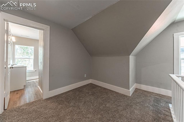 bonus room featuring carpet and lofted ceiling