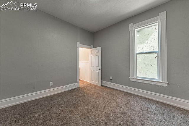 unfurnished bedroom with carpet and multiple windows