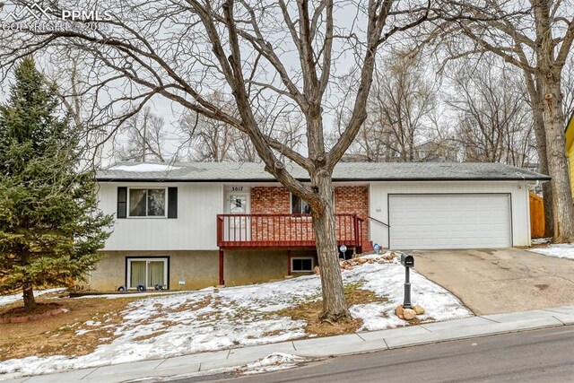 view of front of house with a garage and a deck