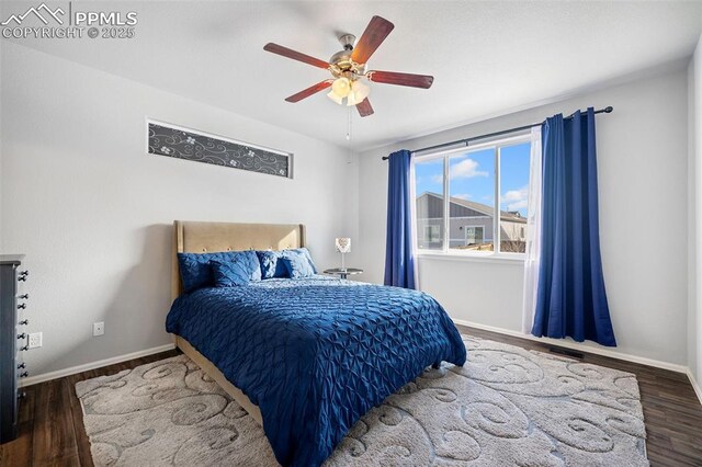 bedroom featuring dark wood-type flooring and ceiling fan