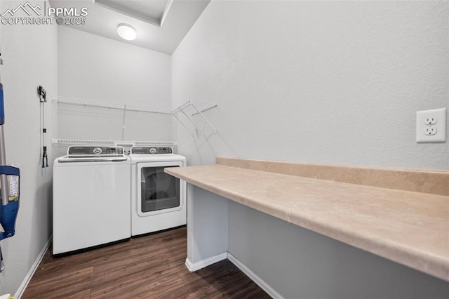 laundry area with dark hardwood / wood-style flooring and washer and clothes dryer