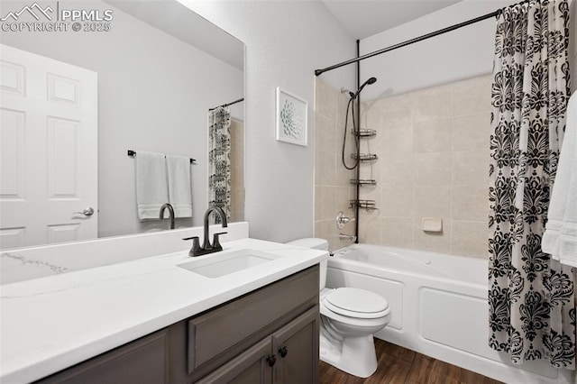 full bathroom featuring vanity, hardwood / wood-style flooring, toilet, and shower / bath combo with shower curtain