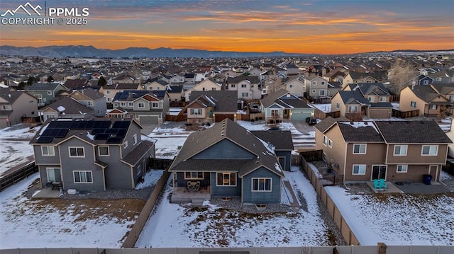 snowy aerial view featuring a mountain view