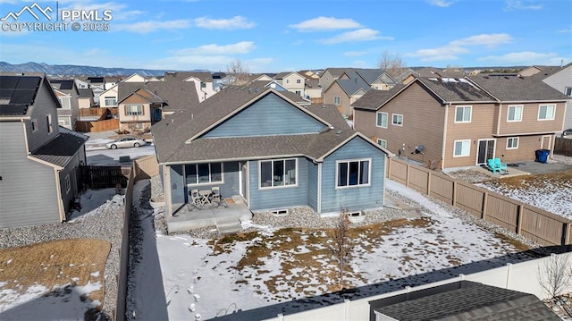 snow covered rear of property featuring covered porch