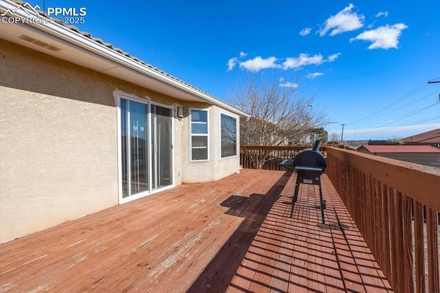 wooden terrace featuring area for grilling