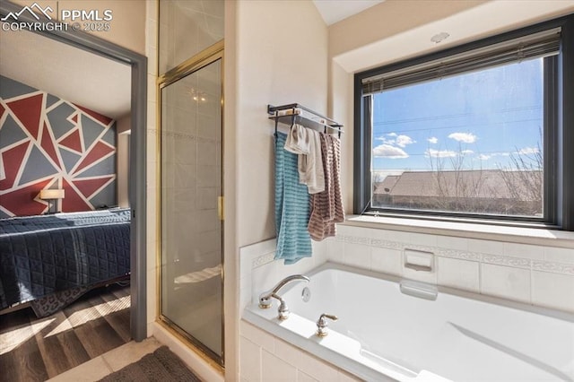 bathroom with wood-type flooring and independent shower and bath