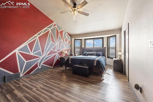 bedroom featuring ceiling fan and dark wood-type flooring