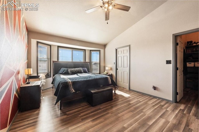 bedroom featuring dark hardwood / wood-style floors, ceiling fan, and lofted ceiling