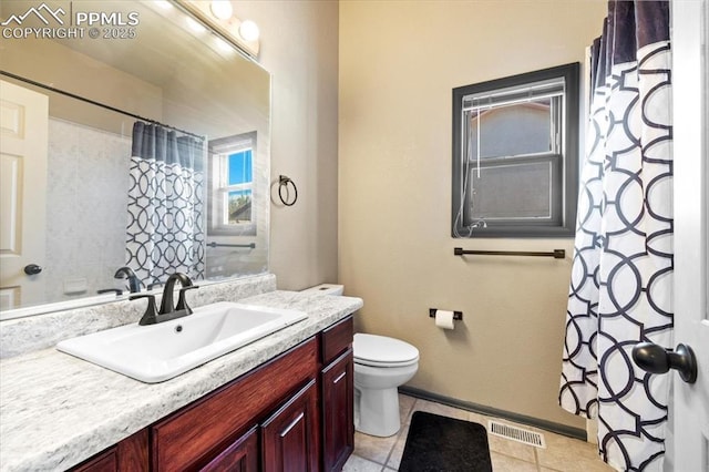 bathroom featuring tile patterned floors, vanity, and toilet