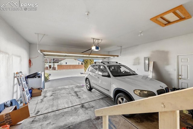 garage featuring electric panel and a garage door opener