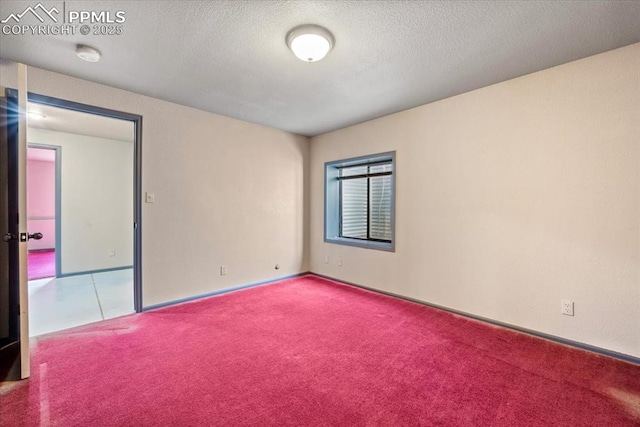 carpeted spare room featuring a textured ceiling