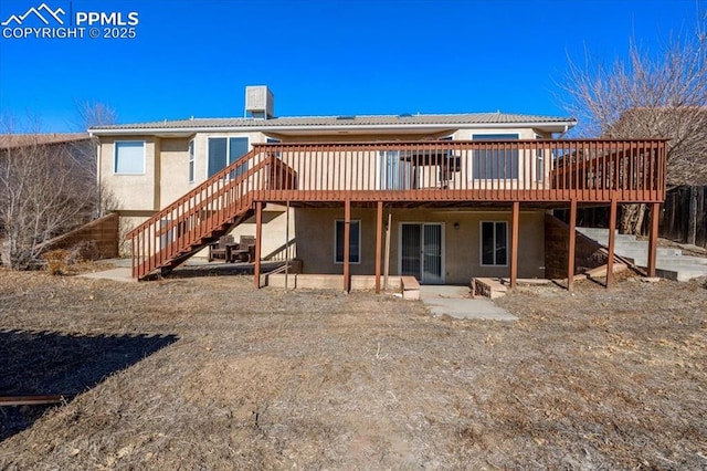 back of property featuring a wooden deck