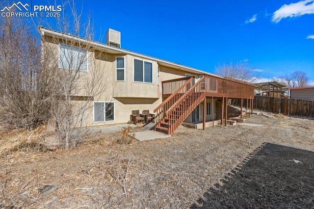 rear view of property featuring a deck