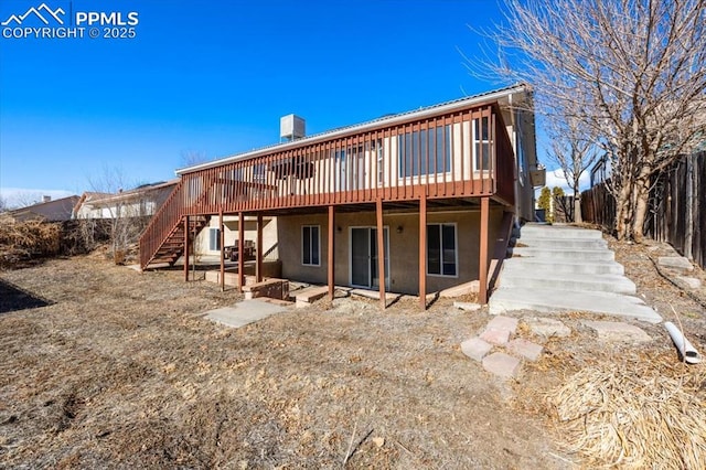 rear view of house with a wooden deck