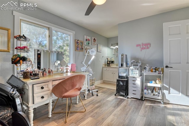 office space with ceiling fan and light hardwood / wood-style floors