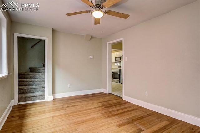 empty room featuring ceiling fan and light hardwood / wood-style flooring