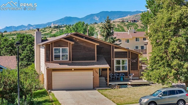 view of front of home featuring a deck with mountain view and a garage